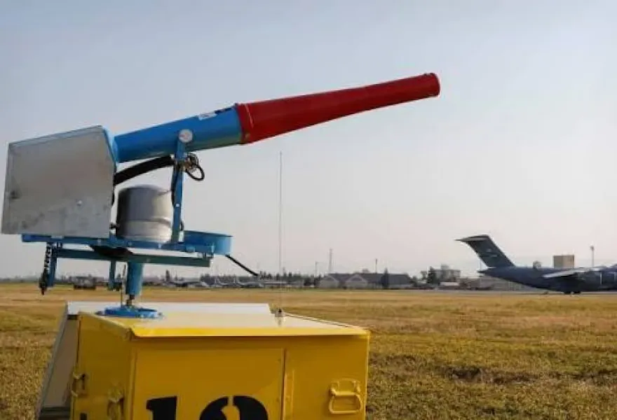 A gas cannon on the airfield grass