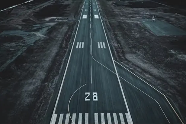 A runway inspection vehicle stopped on the centerline