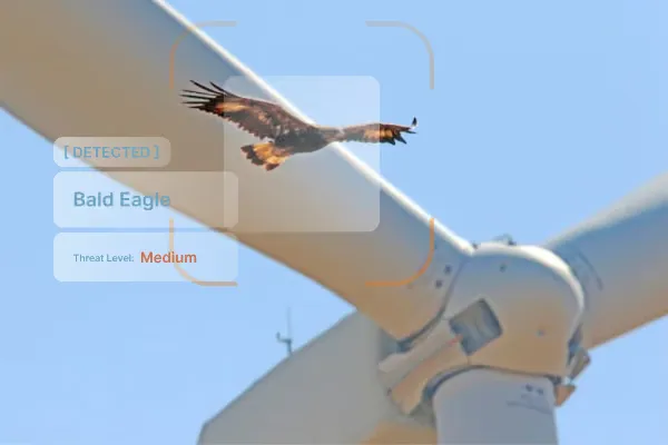 A camera mast beside a turbine at first light